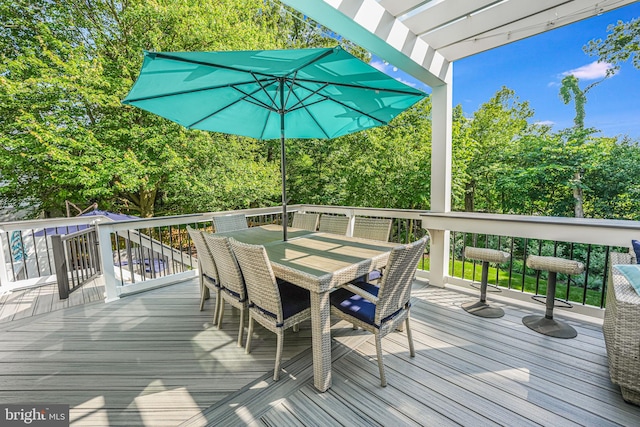 wooden deck with outdoor dining space and a pergola