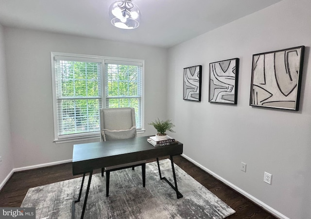 home office with baseboards, dark wood-style flooring, and a wealth of natural light