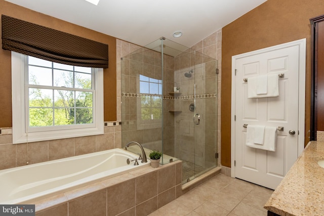 bathroom featuring a shower stall, tile patterned flooring, a garden tub, and vanity