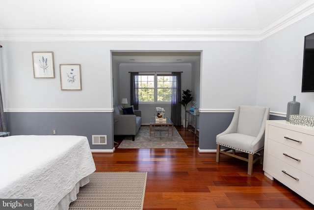 bedroom with ornamental molding, dark wood-type flooring, and baseboards