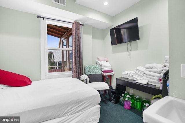 bedroom with visible vents and carpet