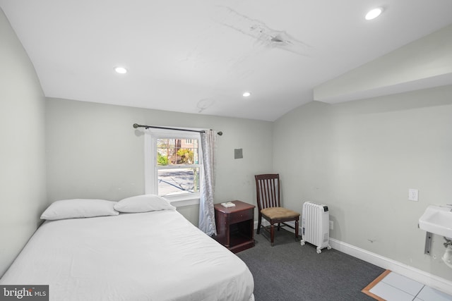 bedroom with recessed lighting, baseboards, dark carpet, and radiator heating unit
