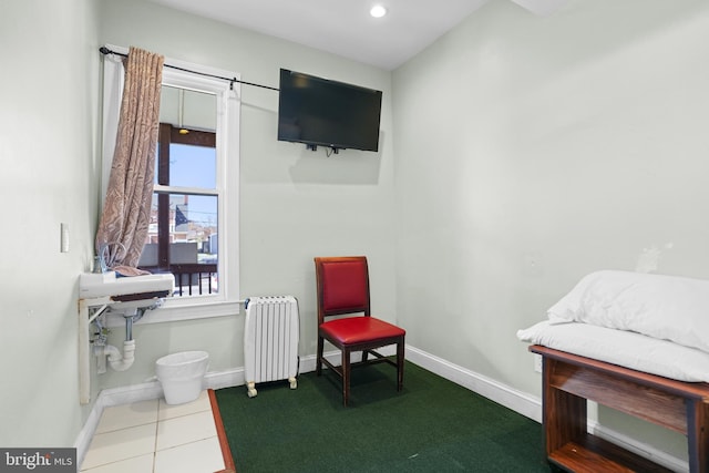 sitting room featuring radiator and baseboards