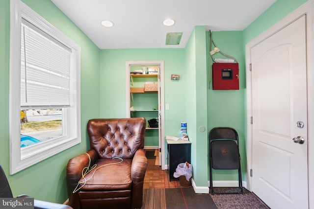 living area with baseboards and recessed lighting