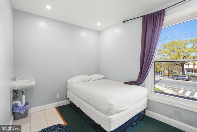 bedroom featuring baseboards, tile patterned floors, and recessed lighting