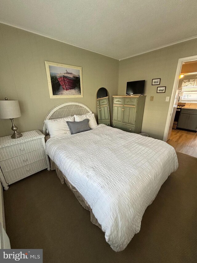 6 122nd St Unit 302, Ocean City, MD 21842 - bedroom with wood finished floors, ornamental molding, and a textured ceiling