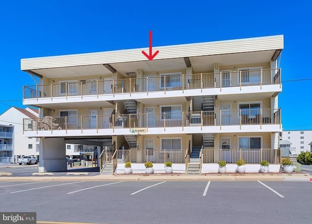 6 122nd St Unit 302, Ocean City, MD 21842 - view of building exterior with uncovered parking and stairway