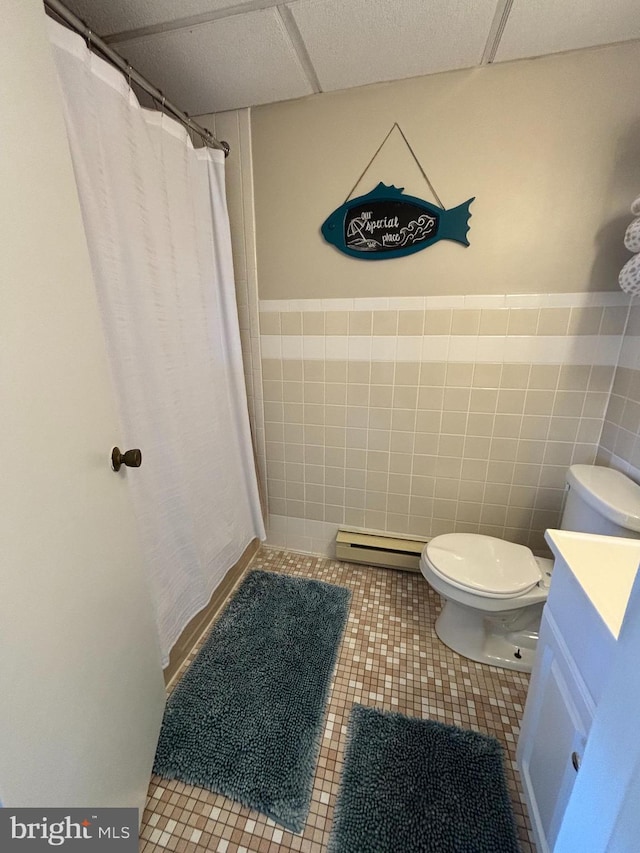 6 122nd St Unit 302, Ocean City, MD 21842 - bathroom with tile patterned flooring, toilet, a baseboard heating unit, and a drop ceiling