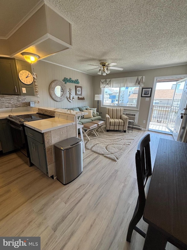 6 122nd St Unit 302, Ocean City, MD 21842 - kitchen featuring light countertops, a wealth of natural light, black range with electric stovetop, and light wood-type flooring