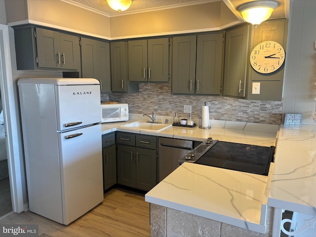 6 122nd St Unit 302, Ocean City, MD 21842 - kitchen with white appliances, tasteful backsplash, light wood-style floors, and a sink