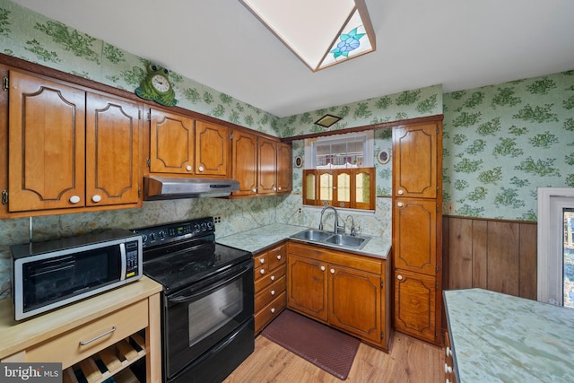 kitchen with wallpapered walls, stainless steel microwave, under cabinet range hood, a sink, and electric range