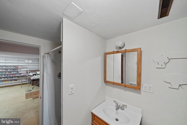 bathroom with a sink, visible vents, tile patterned floors, and a shower with shower curtain