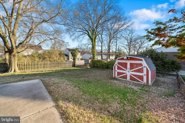 view of yard with an outbuilding, a storage unit, and fence