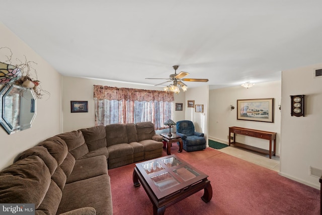 living area with visible vents, baseboards, ceiling fan, light carpet, and light tile patterned floors