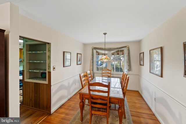 dining room with baseboards and wood finished floors