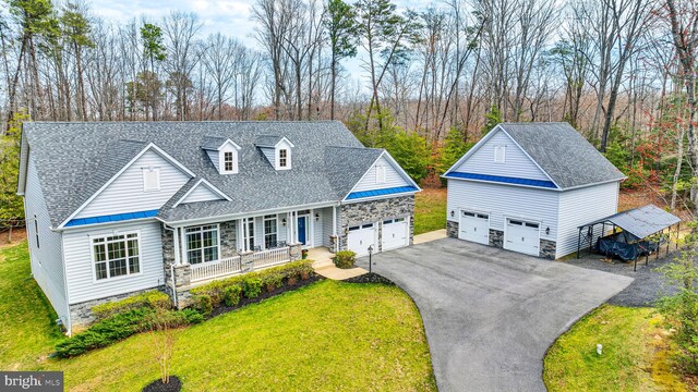 23700 Quiet Oak Ct, California, MD 20619 - view of front facade featuring stone siding, an attached garage, a front lawn, covered porch, and a shingled roof
