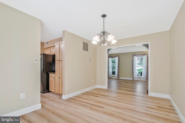 10866 Monticello Ct, Great Falls, VA 22066 - spare room featuring light wood finished floors, a chandelier, and baseboards
