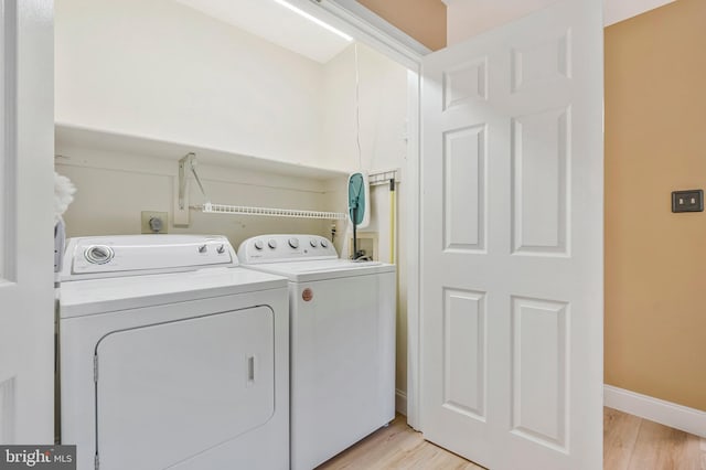 10866 Monticello Ct, Great Falls, VA 22066 - washroom featuring washer and clothes dryer, light wood finished floors, and baseboards
