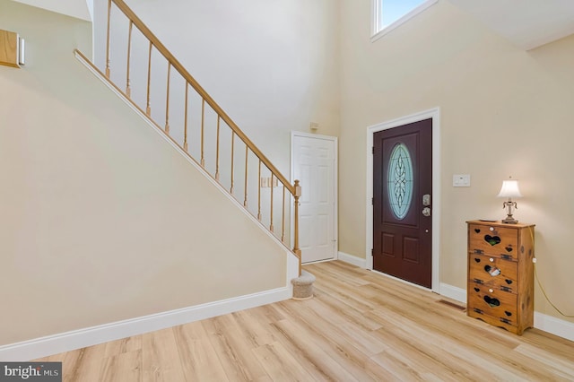 10866 Monticello Ct, Great Falls, VA 22066 - foyer entrance featuring wood finished floors, baseboards, stairway, and a towering ceiling