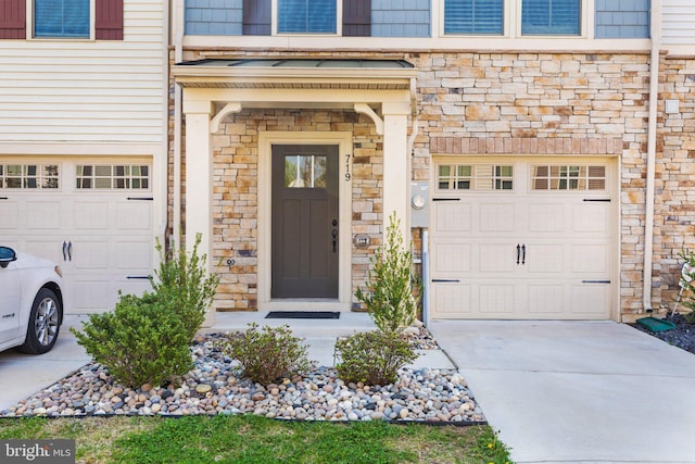 719 Thurlow Ct, Bel Air, MD 21014 - view of exterior entry with concrete driveway, stone siding, and an attached garage