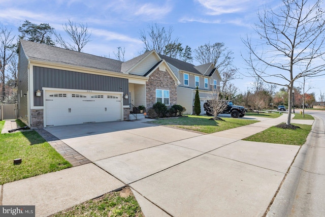 807 Creekside Village Blvd, Glen Burnie, MD 21060 - view of front facade featuring concrete driveway, an attached garage, stone siding, board and batten siding, and a front yard