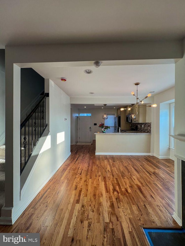 820 S Paca St, Baltimore, MD 21230 - kitchen with a chandelier, backsplash, pendant lighting, freestanding refrigerator, and wood finished floors