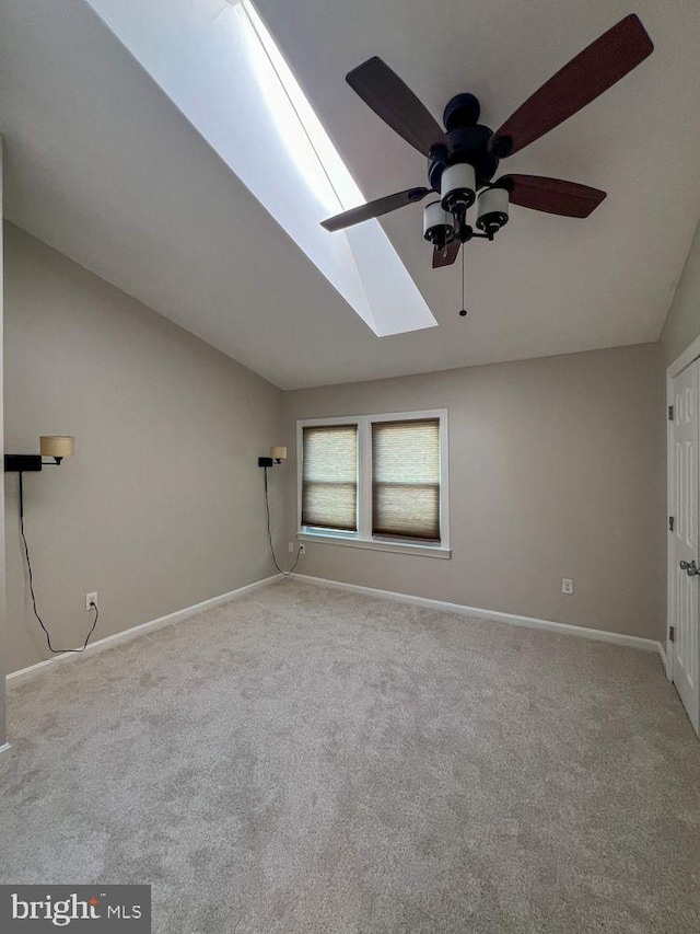 820 S Paca St, Baltimore, MD 21230 - carpeted empty room featuring baseboards, lofted ceiling with skylight, and a ceiling fan
