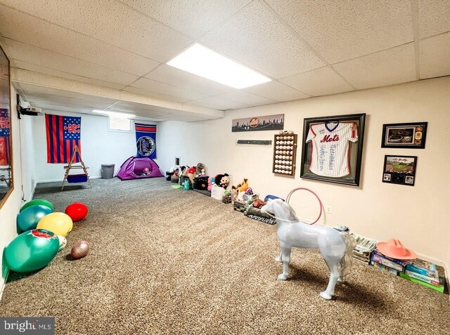 recreation room with carpet flooring and a paneled ceiling