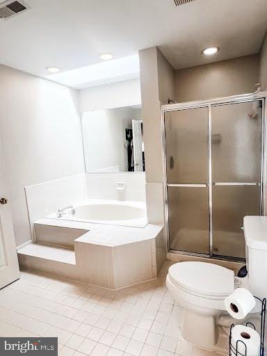 full bath featuring toilet, tile patterned flooring, visible vents, and a stall shower