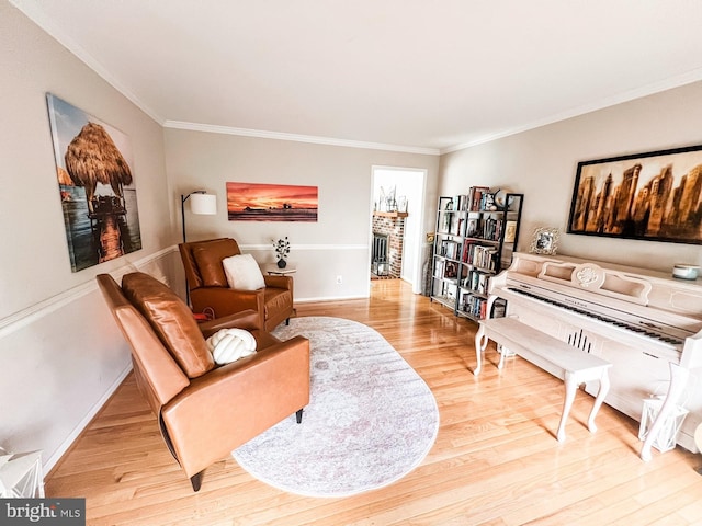 living area with wood finished floors, crown molding, and baseboards