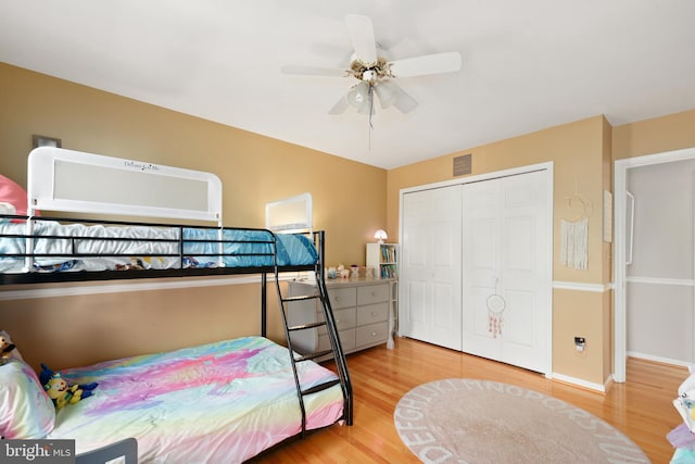 bedroom with wood finished floors, a closet, and ceiling fan