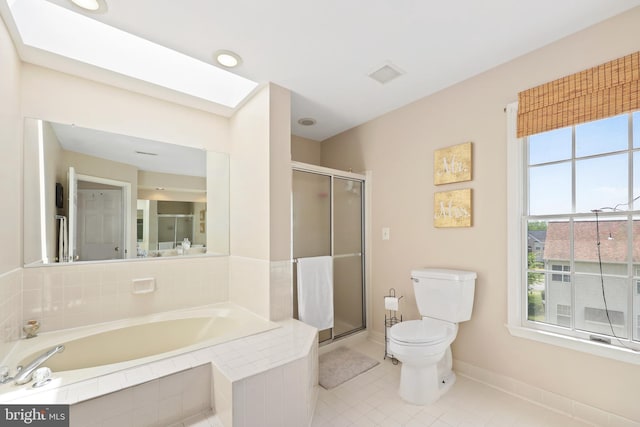 bathroom with a shower stall, toilet, a garden tub, and baseboards