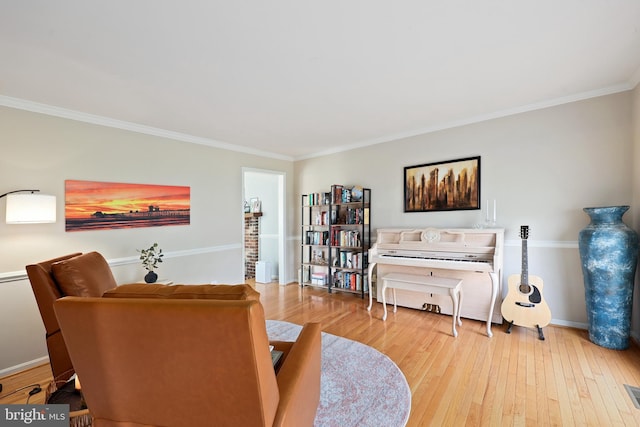 interior space with wood-type flooring, visible vents, crown molding, and baseboards