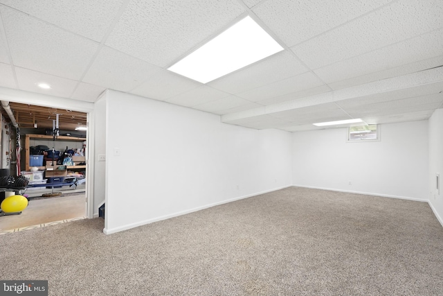below grade area featuring recessed lighting, carpet floors, baseboards, and a paneled ceiling