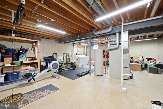 exercise area featuring washing machine and clothes dryer and gas water heater