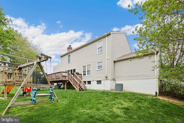 rear view of house with a chimney, stairs, central AC unit, a yard, and a deck