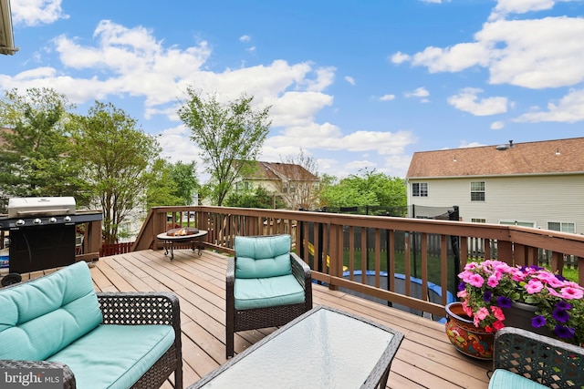 wooden deck featuring area for grilling