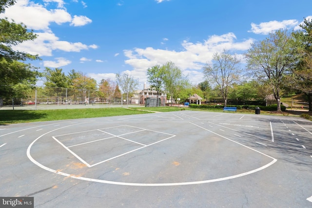 view of sport court with community basketball court, a tennis court, and fence