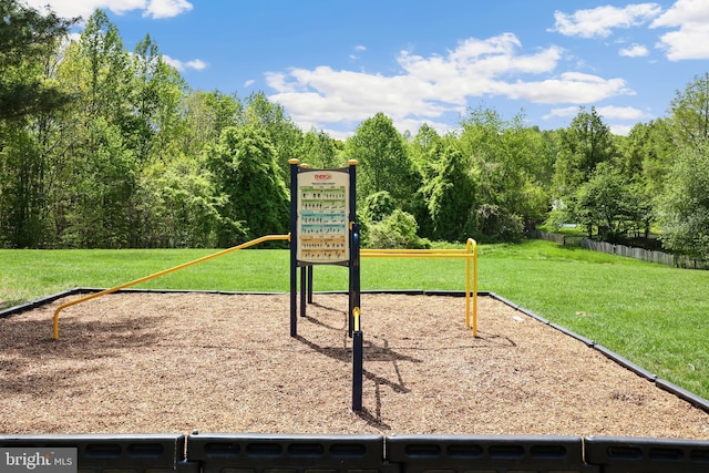 view of community featuring a lawn and fence
