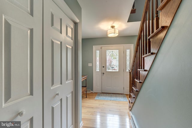 5855 Springmount Ct, Eldersburg, MD 21784 - foyer with baseboards, light wood finished floors, and stairs