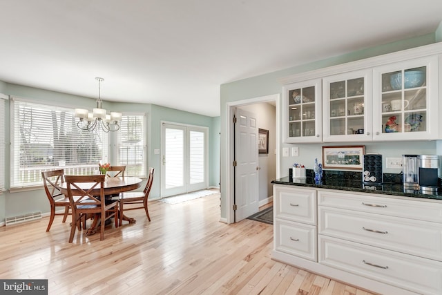 5855 Springmount Ct, Eldersburg, MD 21784 - kitchen featuring light wood-type flooring, a chandelier, white cabinetry, and a healthy amount of sunlight