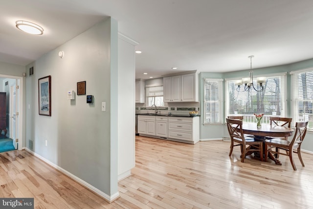 5855 Springmount Ct, Eldersburg, MD 21784 - dining space featuring baseboards, a notable chandelier, and light wood-style floors