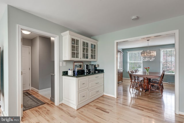 5855 Springmount Ct, Eldersburg, MD 21784 - kitchen featuring white cabinets, light wood-style flooring, baseboards, and glass insert cabinets