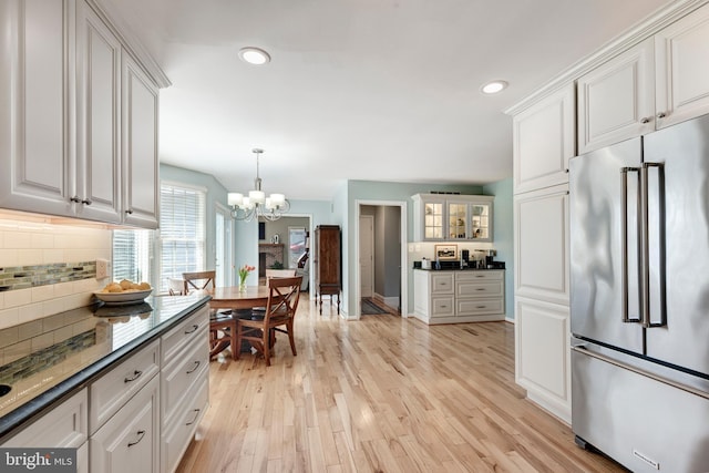 5855 Springmount Ct, Eldersburg, MD 21784 - kitchen featuring tasteful backsplash, an inviting chandelier, high quality fridge, light wood-style flooring, and white cabinets
