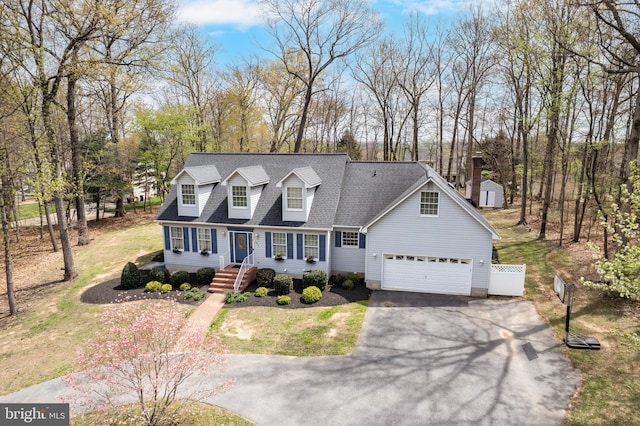 5855 Springmount Ct, Eldersburg, MD 21784 - cape cod home featuring a shed, aphalt driveway, an outbuilding, a garage, and roof with shingles