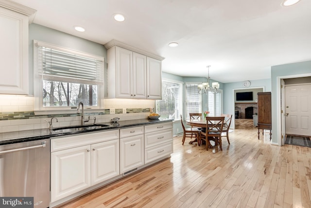 5855 Springmount Ct, Eldersburg, MD 21784 - kitchen featuring dishwasher, a healthy amount of sunlight, a notable chandelier, and a sink