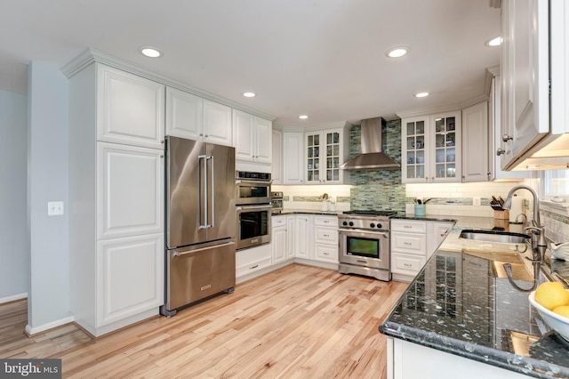 5855 Springmount Ct, Eldersburg, MD 21784 - kitchen with wall chimney range hood, light wood finished floors, premium appliances, and a sink