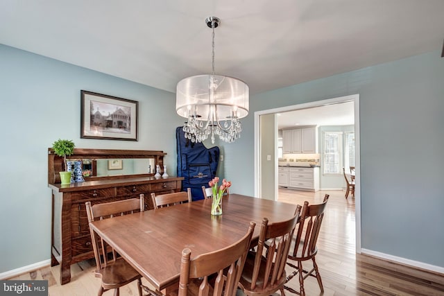 5855 Springmount Ct, Eldersburg, MD 21784 - dining area featuring baseboards, a chandelier, and light wood-type flooring