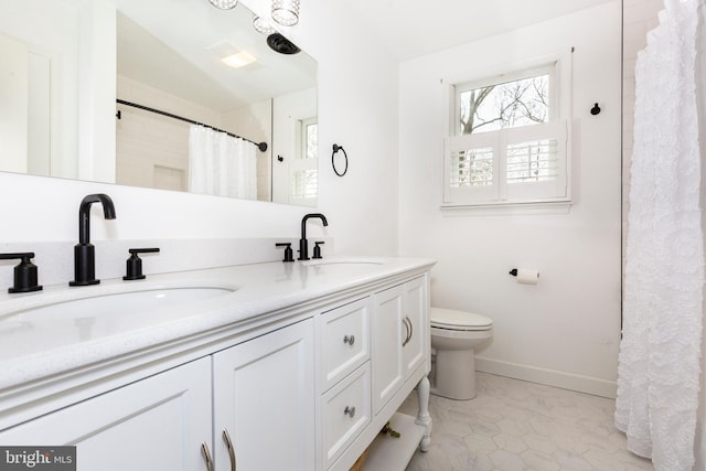 5855 Springmount Ct, Eldersburg, MD 21784 - bathroom featuring baseboards, toilet, a sink, and a healthy amount of sunlight