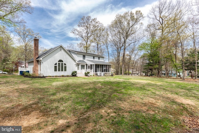 5855 Springmount Ct, Eldersburg, MD 21784 - rear view of house with a chimney, a sunroom, and a yard